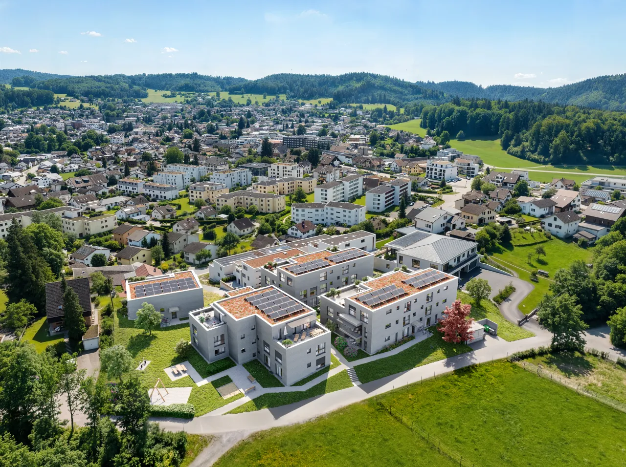 Bird's-eye rendering of three new apartment buildings with solar roofs in a suburban town